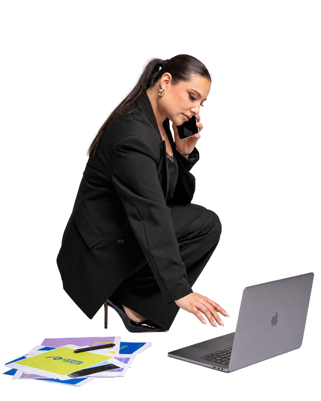 Alejandra on the phone beside her laptop, brand papers, and pens