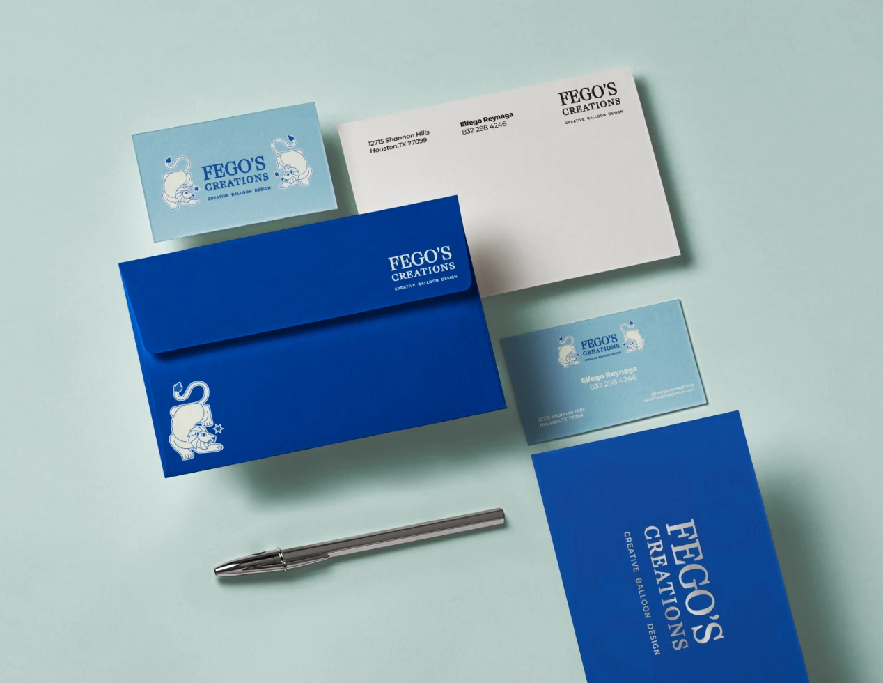 Fego’s Creations business cards, envelope, and stationery in its blue palette